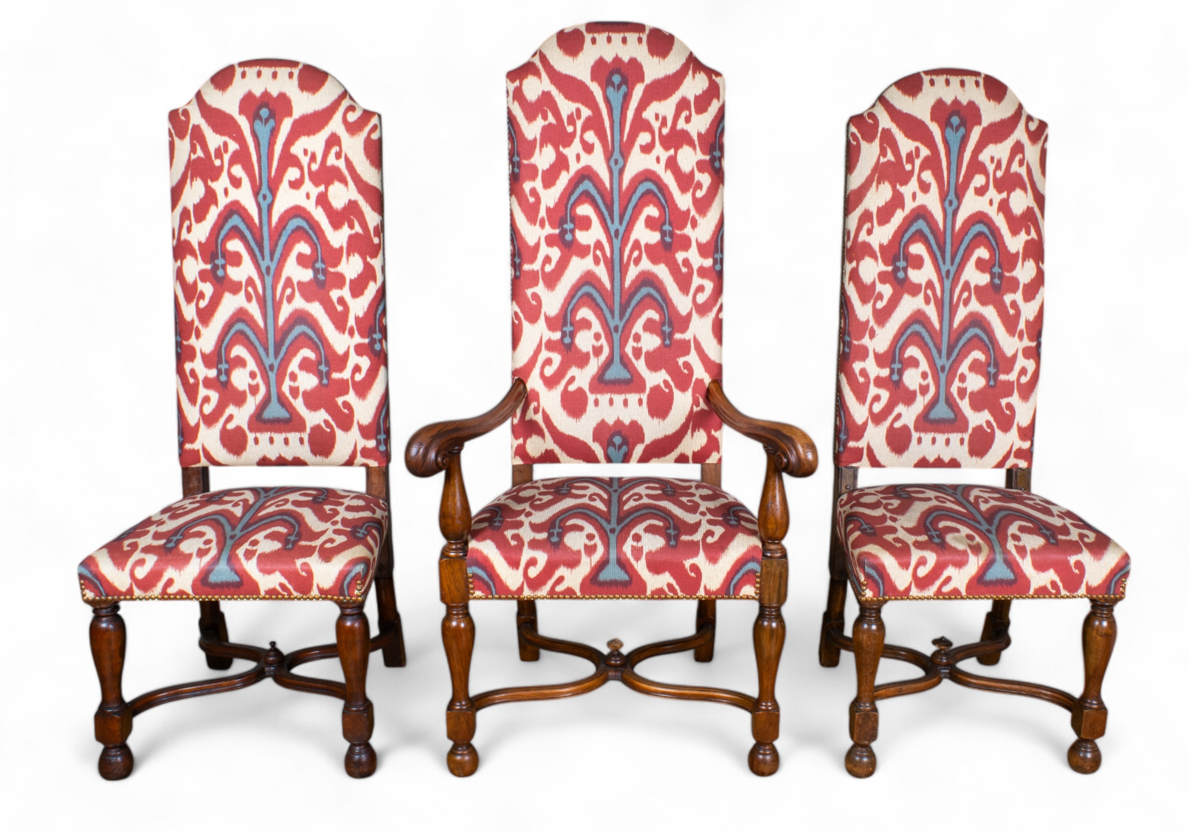 A set of 12 high-back dining chairs, including two carvers, with curved X-frame stretcher. Upholstered in Christopher Farr 'belfour' pattern designed by Michael Szell.